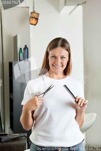 Image of Hairdresser Holding Comb And Scissors