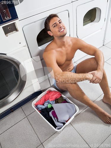 Image of Man With Laundry Basket Waiting To Wash Clothes