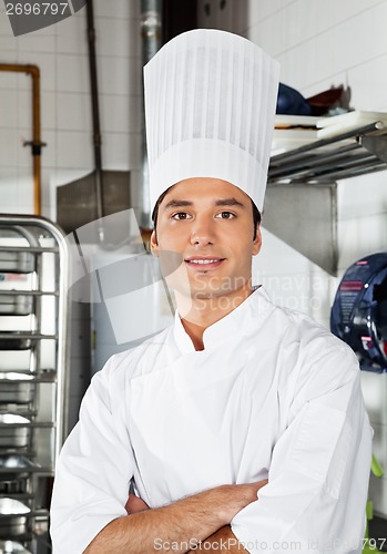 Image of Young Chef With Arms Crossed In Kitchen