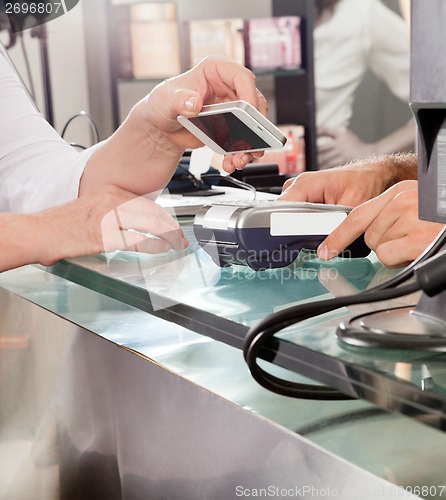 Image of Customer Paying With Mobilephone Using NFC