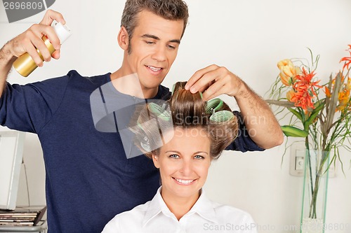Image of Client With Hairdresser Setting Curls With Hairspray