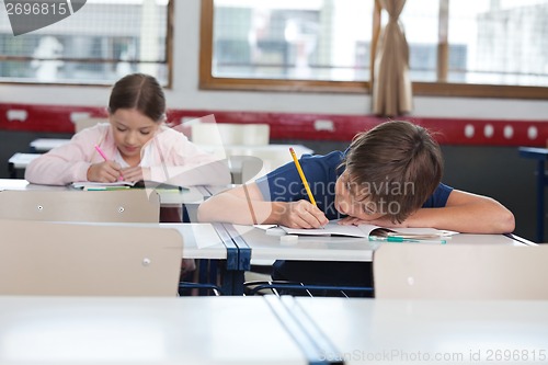 Image of Boy And Girl Studying In Classroom