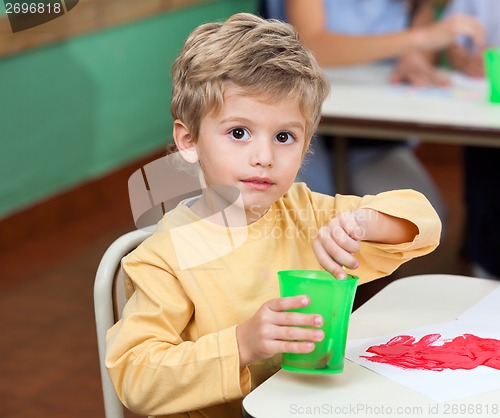 Image of Little Boy Washing Paintbrush In Glass