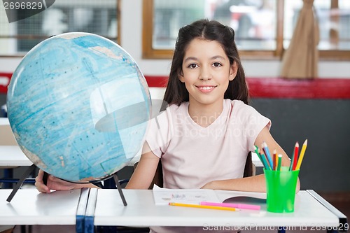 Image of Schoolgirl Smiling With Globe