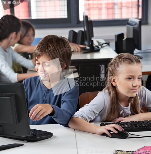 Image of Schoolchildren Using Computer At Desk