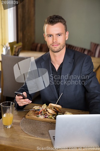 Image of Business man With Mobile phone And Laptop