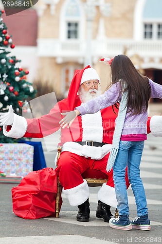 Image of Girl About To Embrace Santa Claus