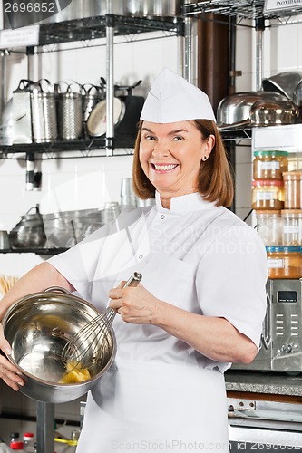 Image of Happy Chef Mixing Egg With Wire Whisk In Bowl