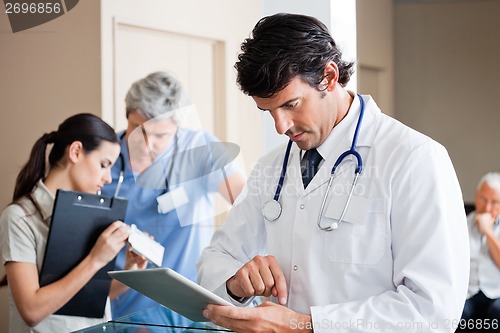 Image of Male Doctor Using Digital Tablet