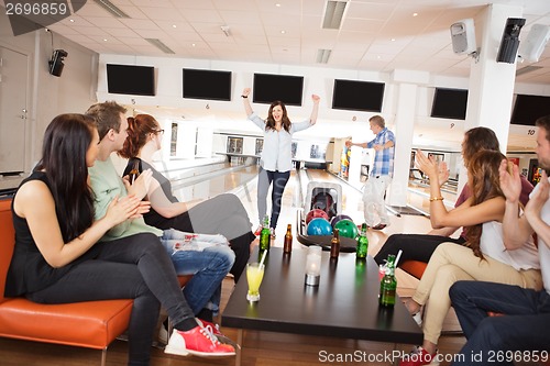 Image of Friends Applauding For People Bowling