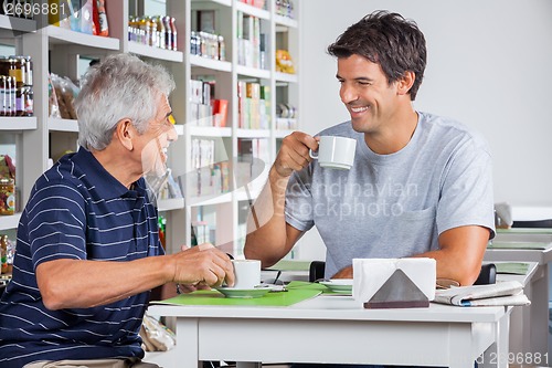 Image of Father And Son Communicating While Having Coffee