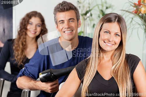 Image of Happy Team Of Hairstylists At Salon