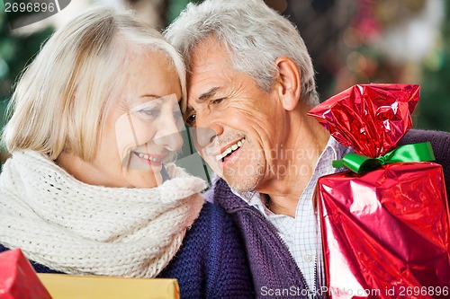 Image of Loving Couple With Christmas Presents In Store