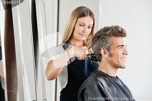 Image of Female Hairdresser Cutting Client's Hair