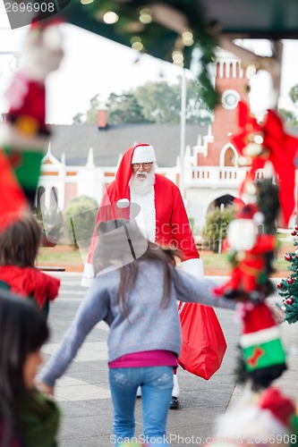 Image of Children Running To Embrace Santa Claus