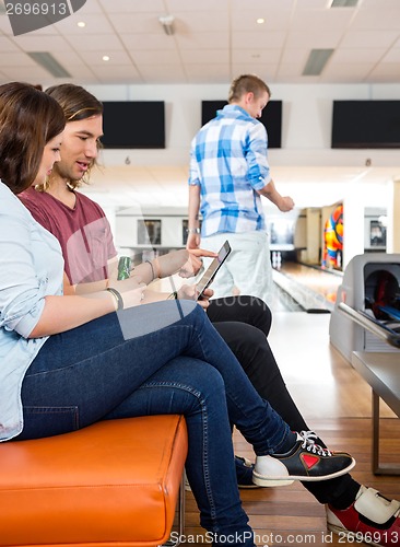 Image of Couple Using Digital Tablet in Bowling Club