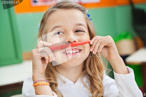 Image of Girl Playing With Clay In Kindergarten