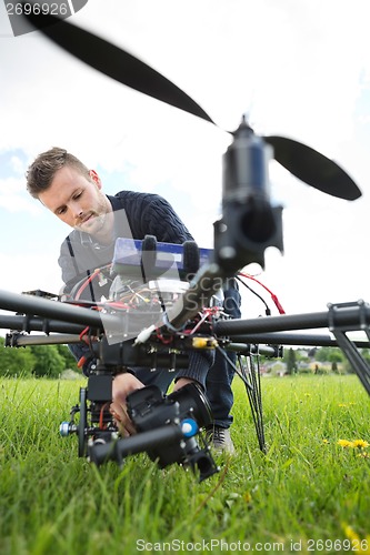 Image of Technician Fixing Camera On Spy Drone