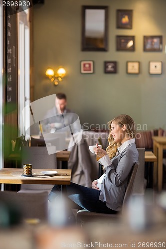 Image of Pregnant Woman Having Coffee While Looking Away
