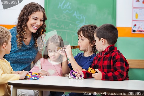 Image of Teacher With Children Playing Musical Instruments