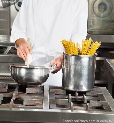 Image of Male Chef Cooking Food In Kitchen