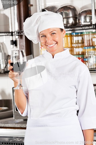 Image of Happy Chef Holding Glass Of Red Wine