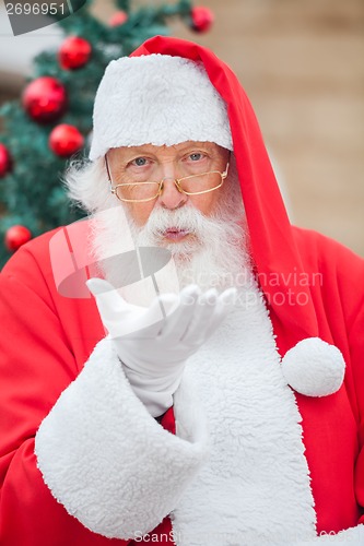 Image of Santa Claus Blowing Kiss Outdoors