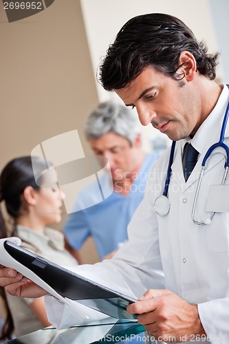 Image of Doctor Reading Document At Reception