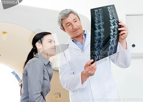 Image of Radiologist And Patient Looking At X-ray