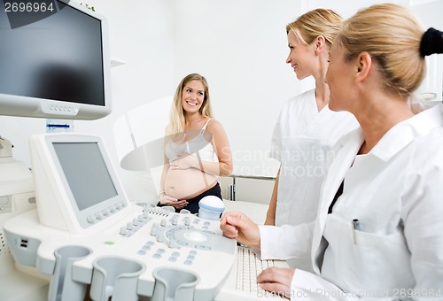 Image of Gynecologists Looking At Pregnant Woman