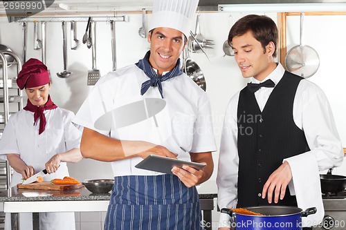 Image of Chef With Waiter Using Digital Tablet