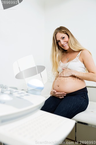 Image of Pregnant Woman Sitting By Ultrasound Machine