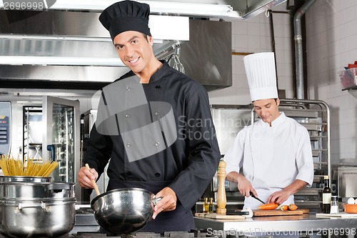 Image of Chefs Cooking Food In Kitchen
