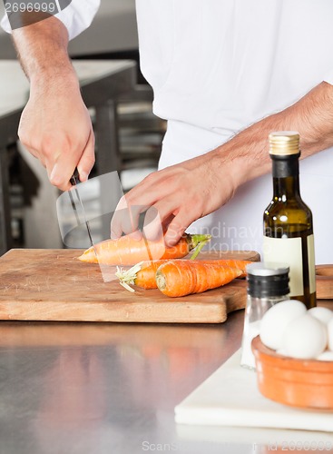 Image of Male Chef Cutting Carrots