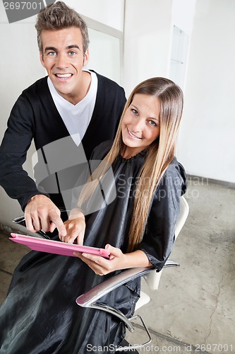 Image of Hairstylist With Client Using Digital Tablet