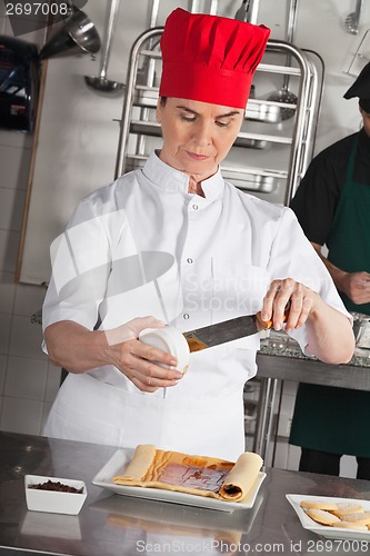 Image of Female Chef Preparing Chocolate Roll