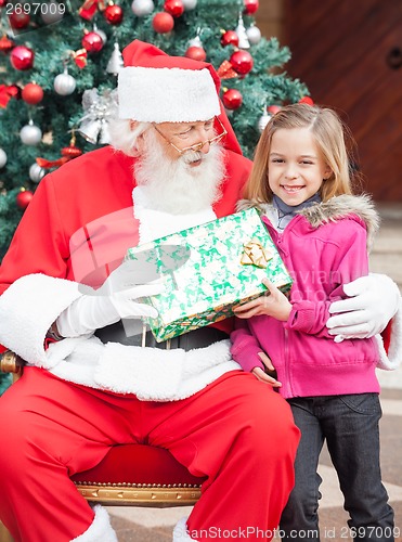Image of Girl Taking Present From Santa Claus