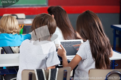 Image of Schoolgirl Using Digital Tablet At Desk