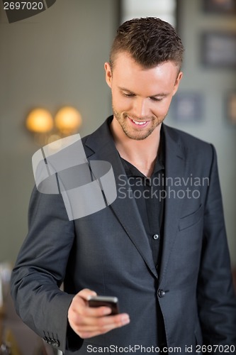 Image of Businessman Text Messaging On Mobilephone