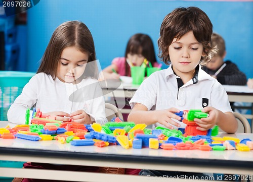Image of Children Playing With Construction Blocks In Classroom