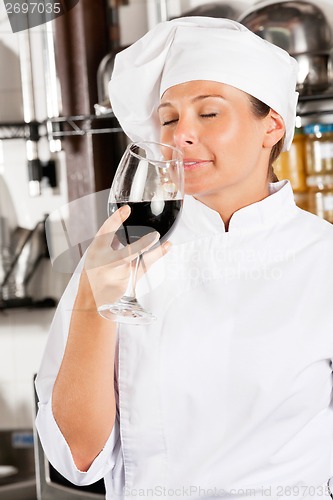 Image of Female Chef Smelling Red Wine