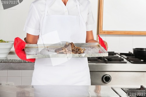 Image of Female Chef With Tray Of Roasted Meat