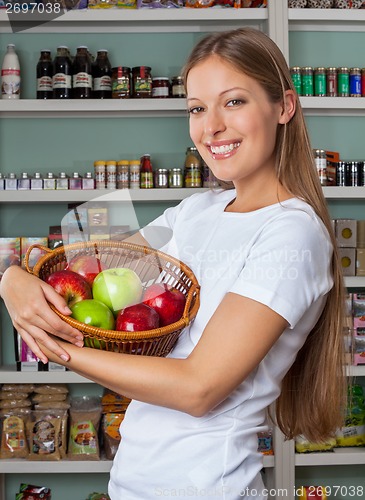 Image of Woman Holding Fruits Basket At Supermarket