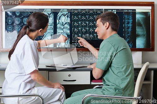 Image of Medical Technicians Pointing At MRI X-ray