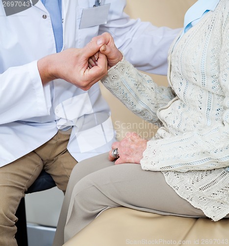 Image of Doctor Comforting Female Patient