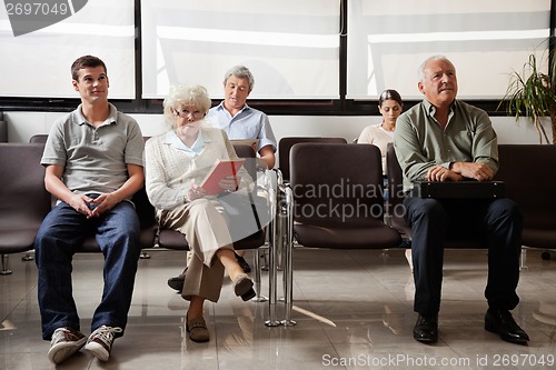 Image of People Sitting In Hospital Lobby