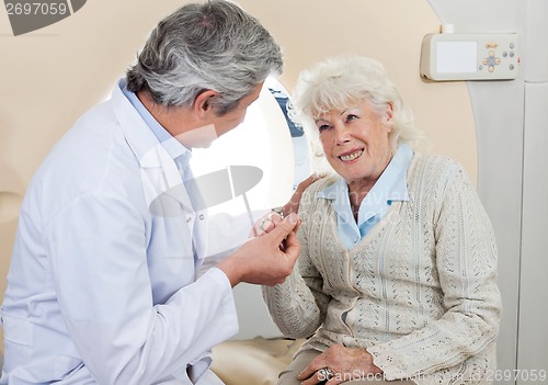 Image of Doctor Comforting Senior Female Patient