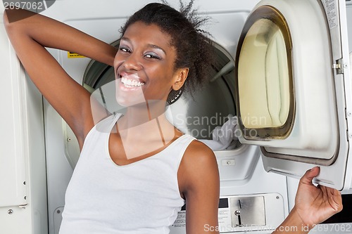 Image of Woman Standing In Front Of Dryer