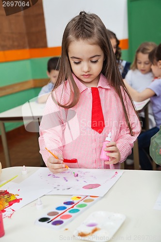 Image of Girl With Watercolor And Paintbrush Painting At Desk