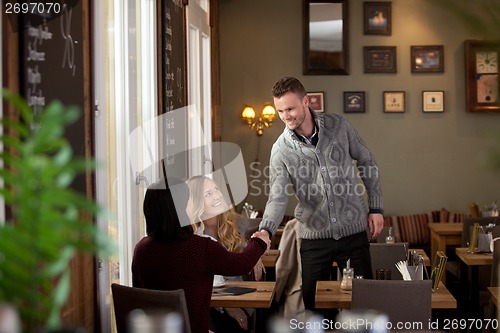 Image of Young Man in Cafe Inroducing Himself